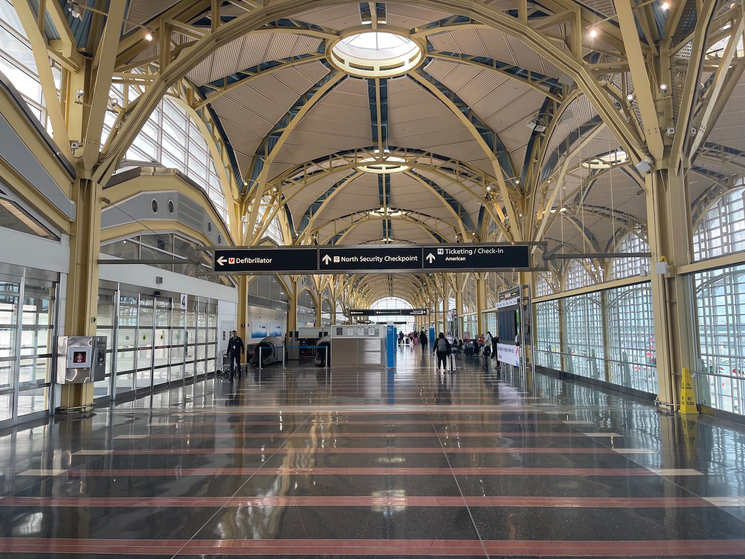 a large hall with a tiled floor and a large window