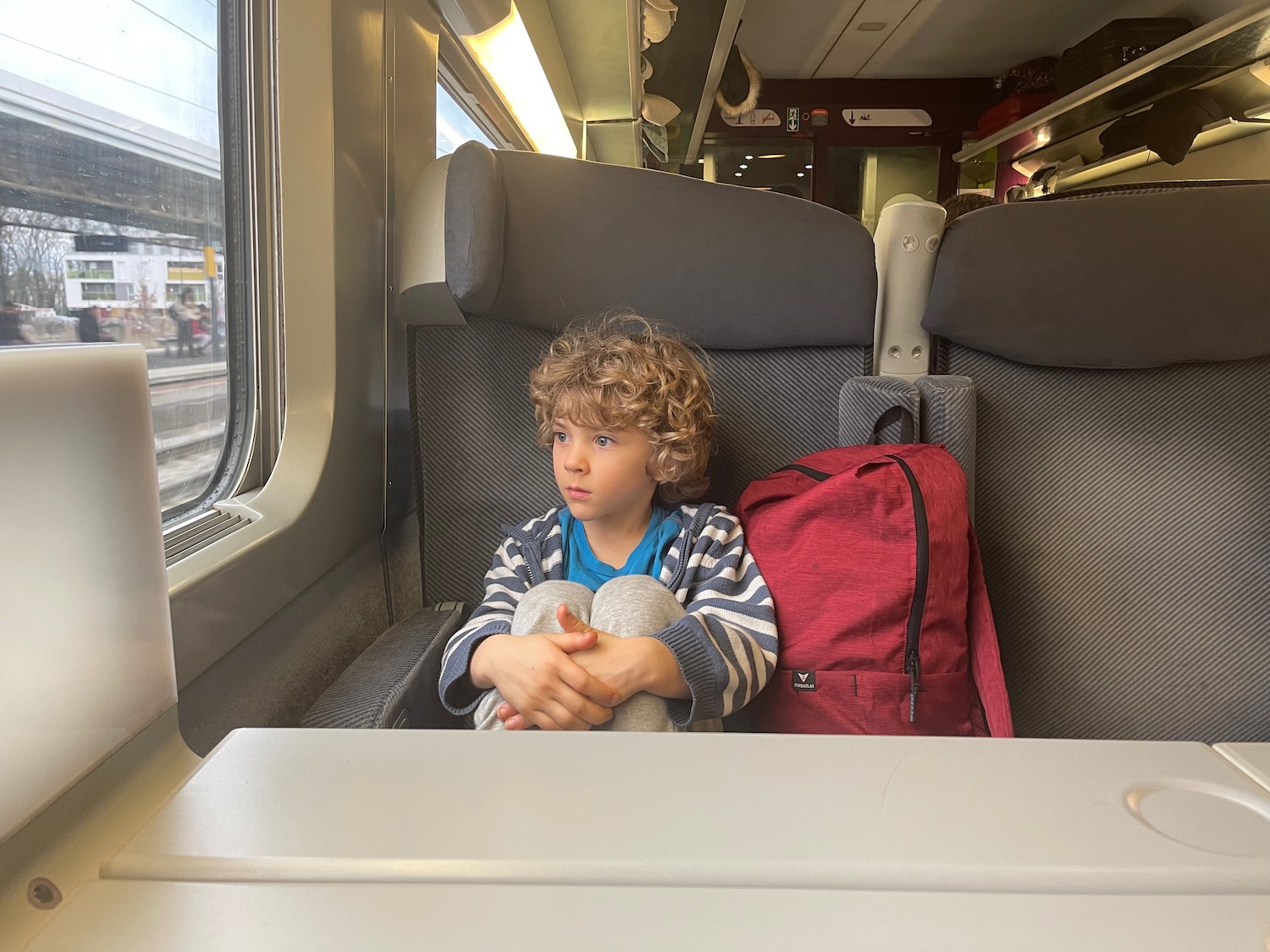 a boy sitting in a train seat
