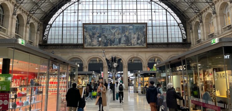 a group of people walking in a train station