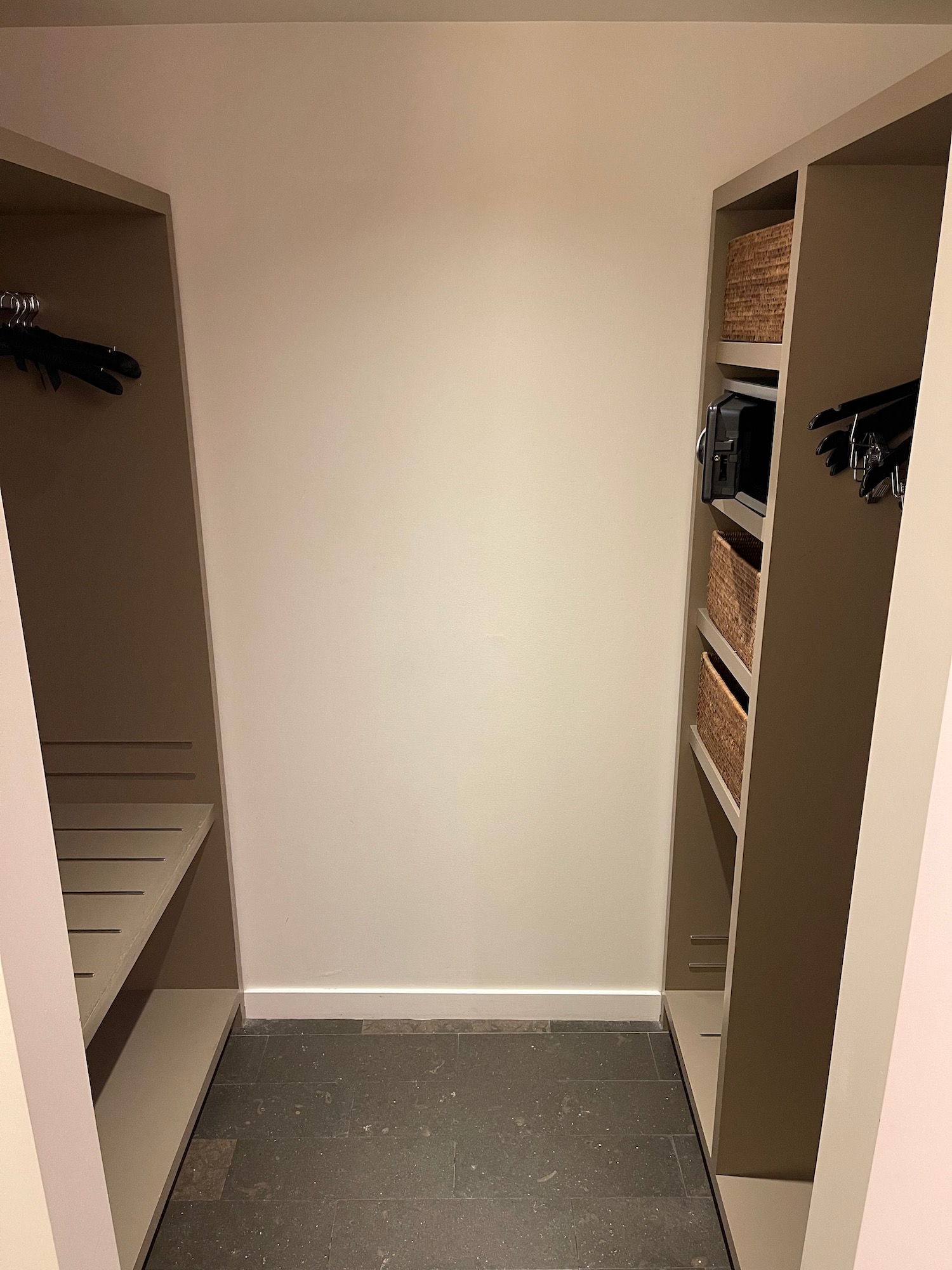 a closet with shelves and a microwave