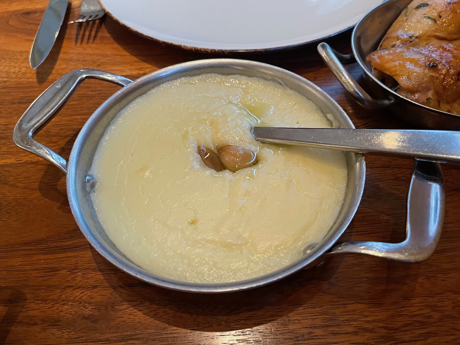 a pot of mashed potatoes with a spoon in it