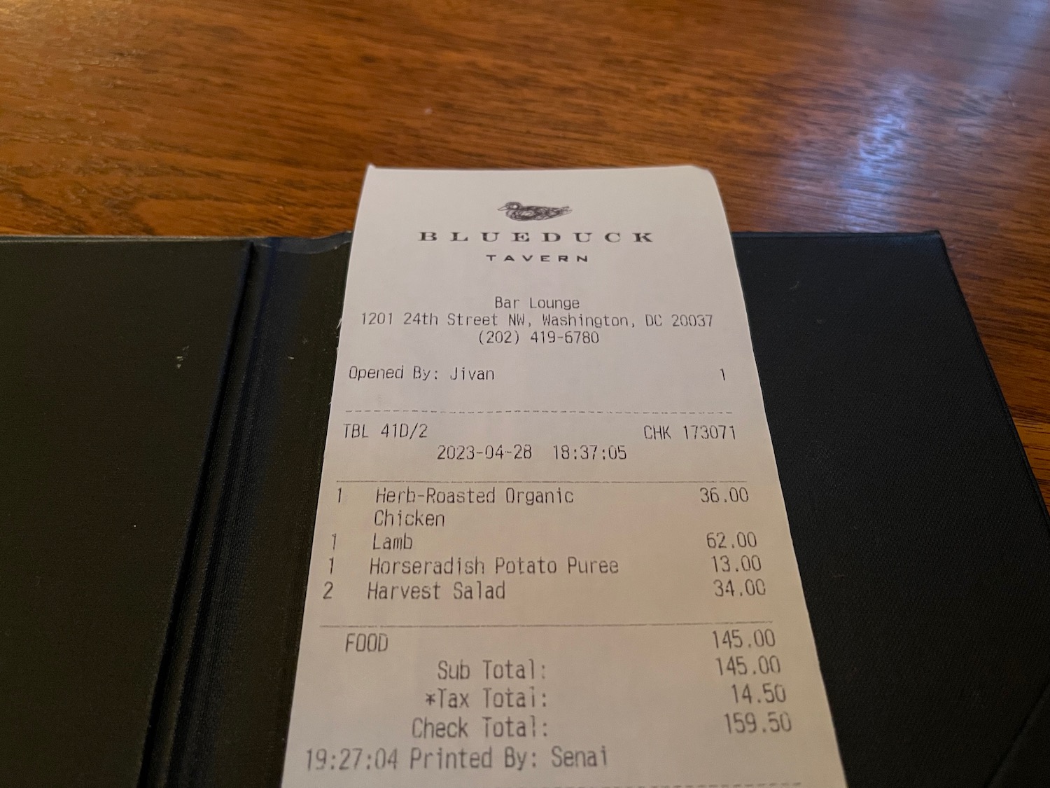 a receipt on a restaurant cover