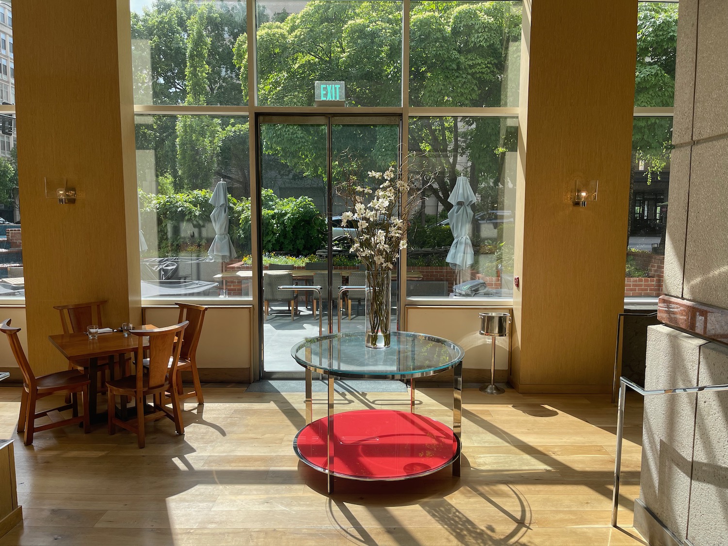 a glass table with a vase of flowers in it