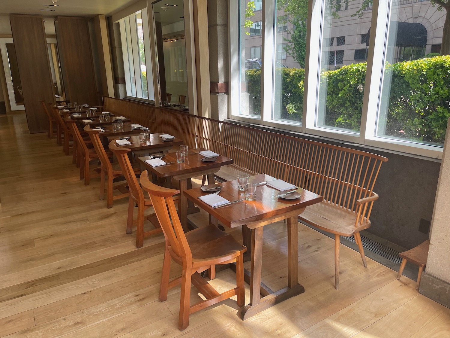 a long row of tables and chairs in a restaurant