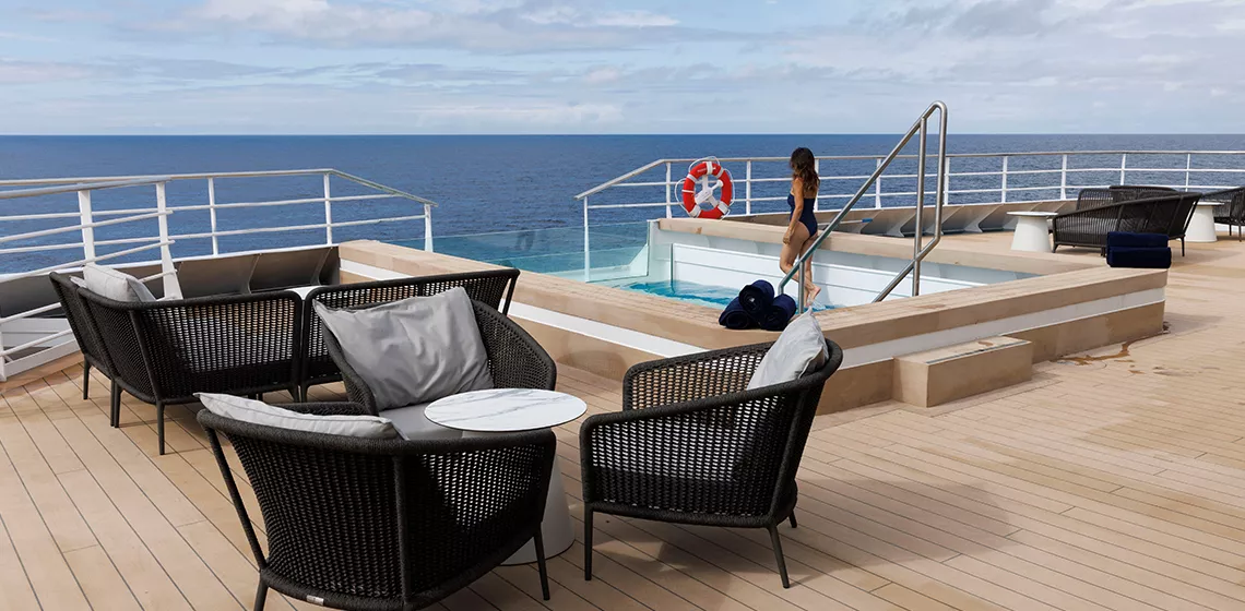 a woman in a swimsuit on a deck of a cruise ship