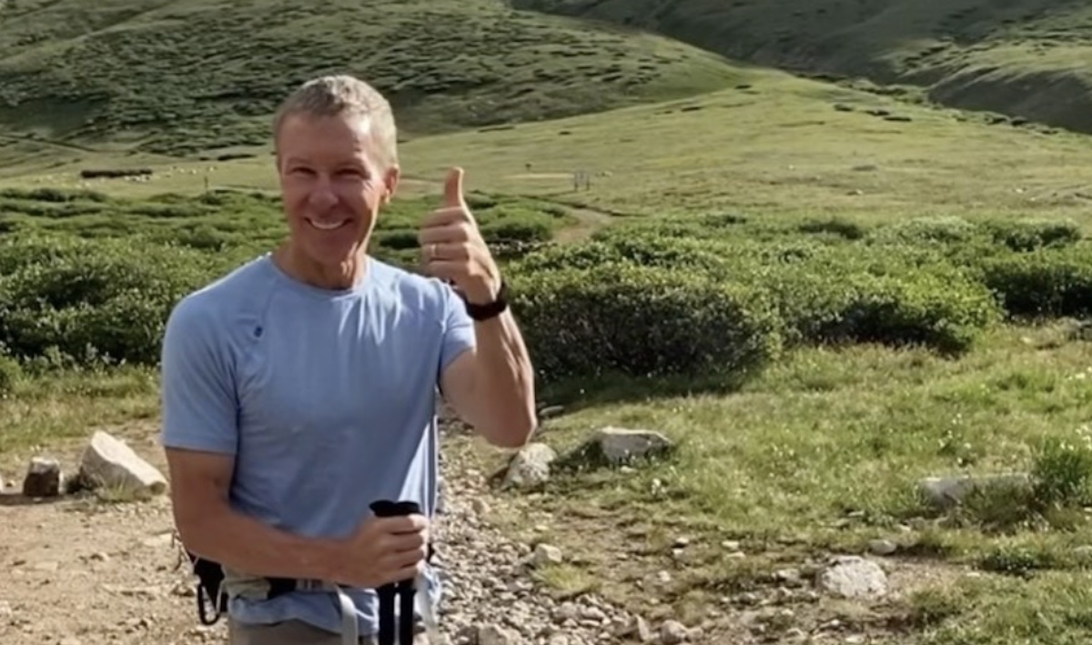 a man with poles giving a thumbs up