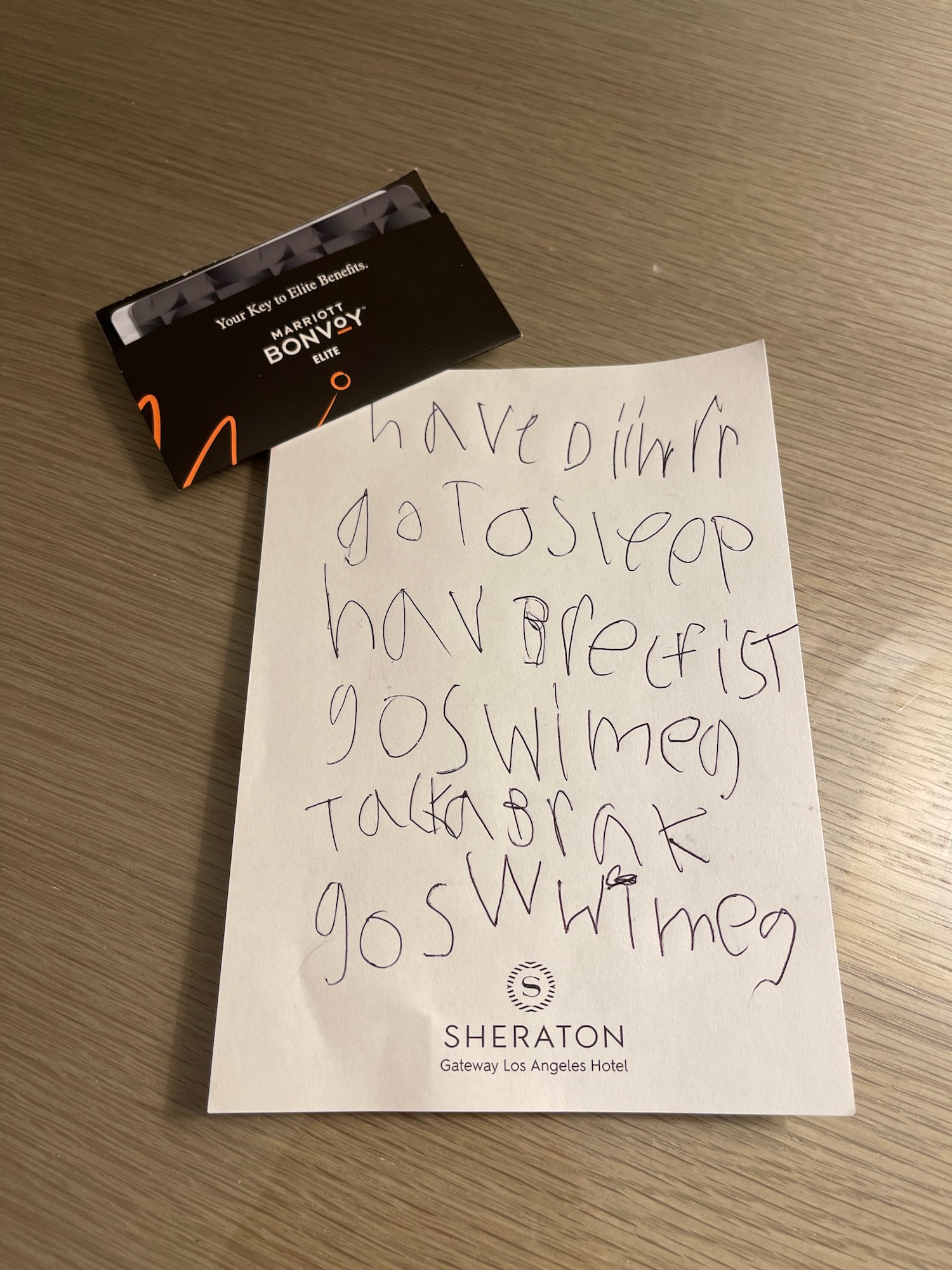 a piece of paper with writing on it next to a black card