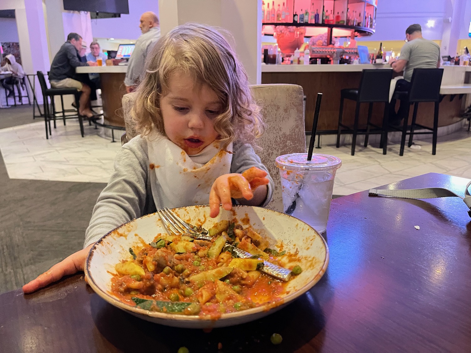 a child eating food at a restaurant