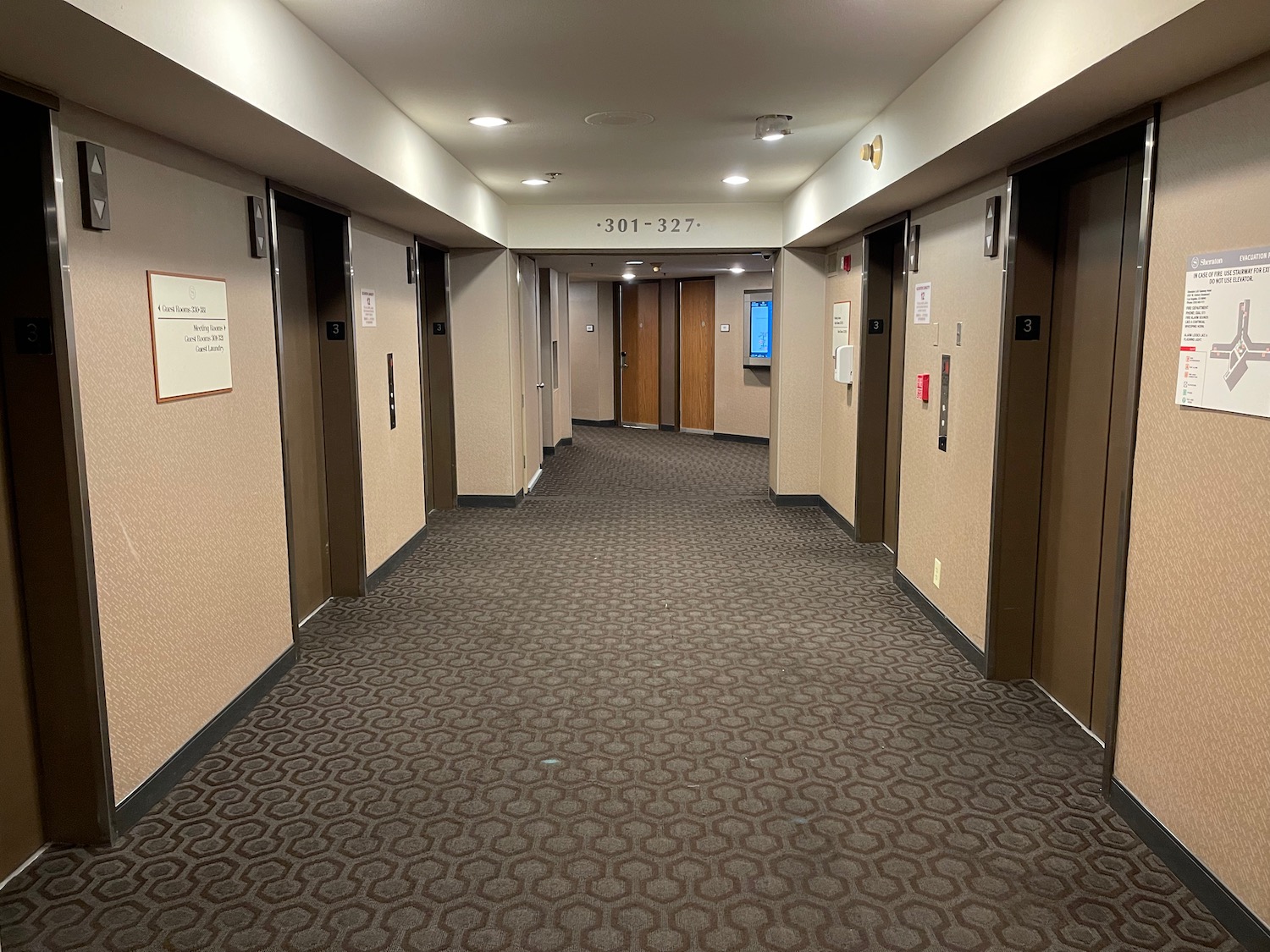 a hallway with several elevators