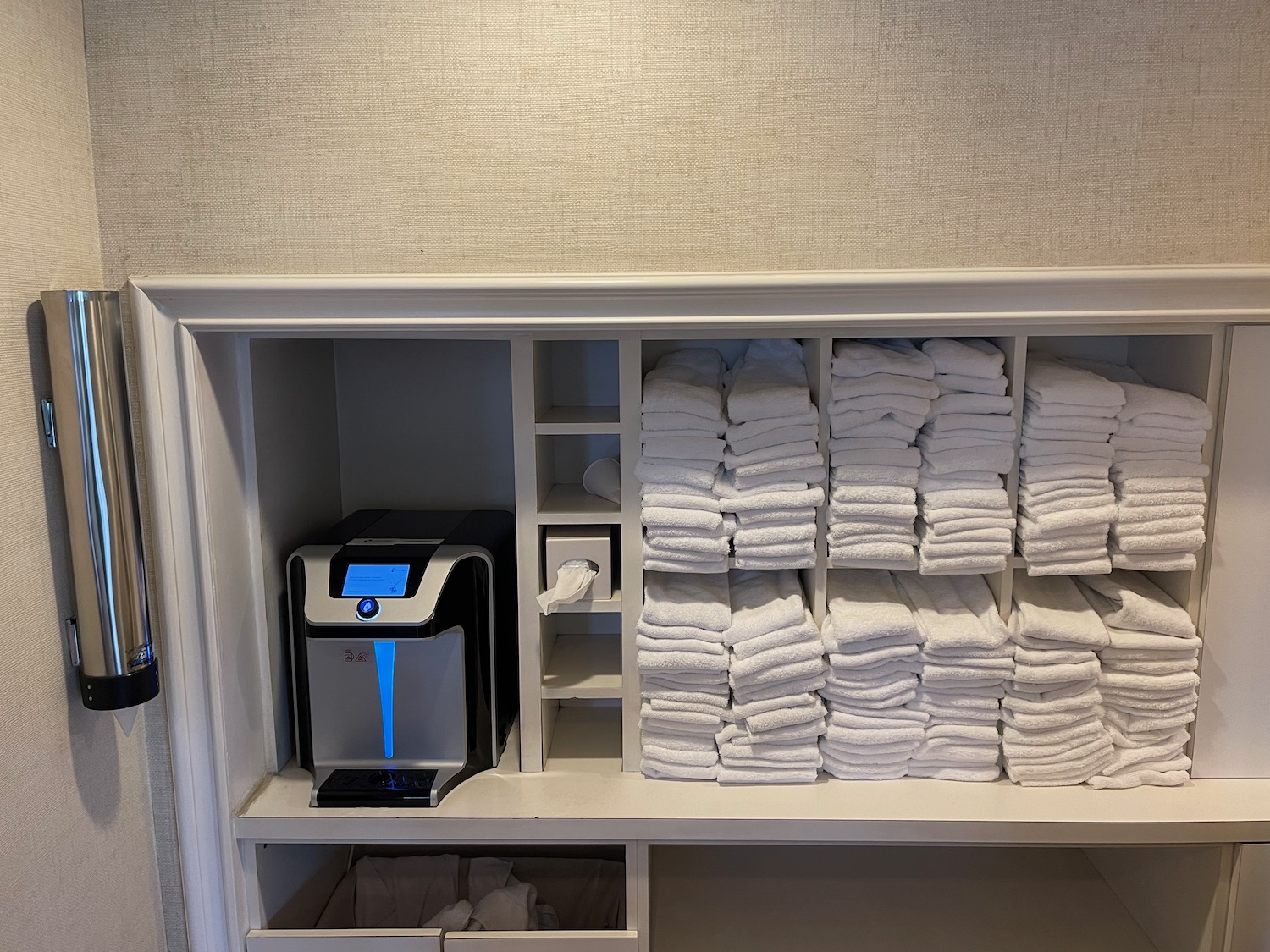 a shelf with towels and a machine