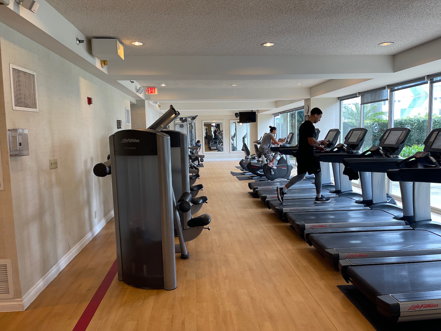 a man running on treadmills in a gym