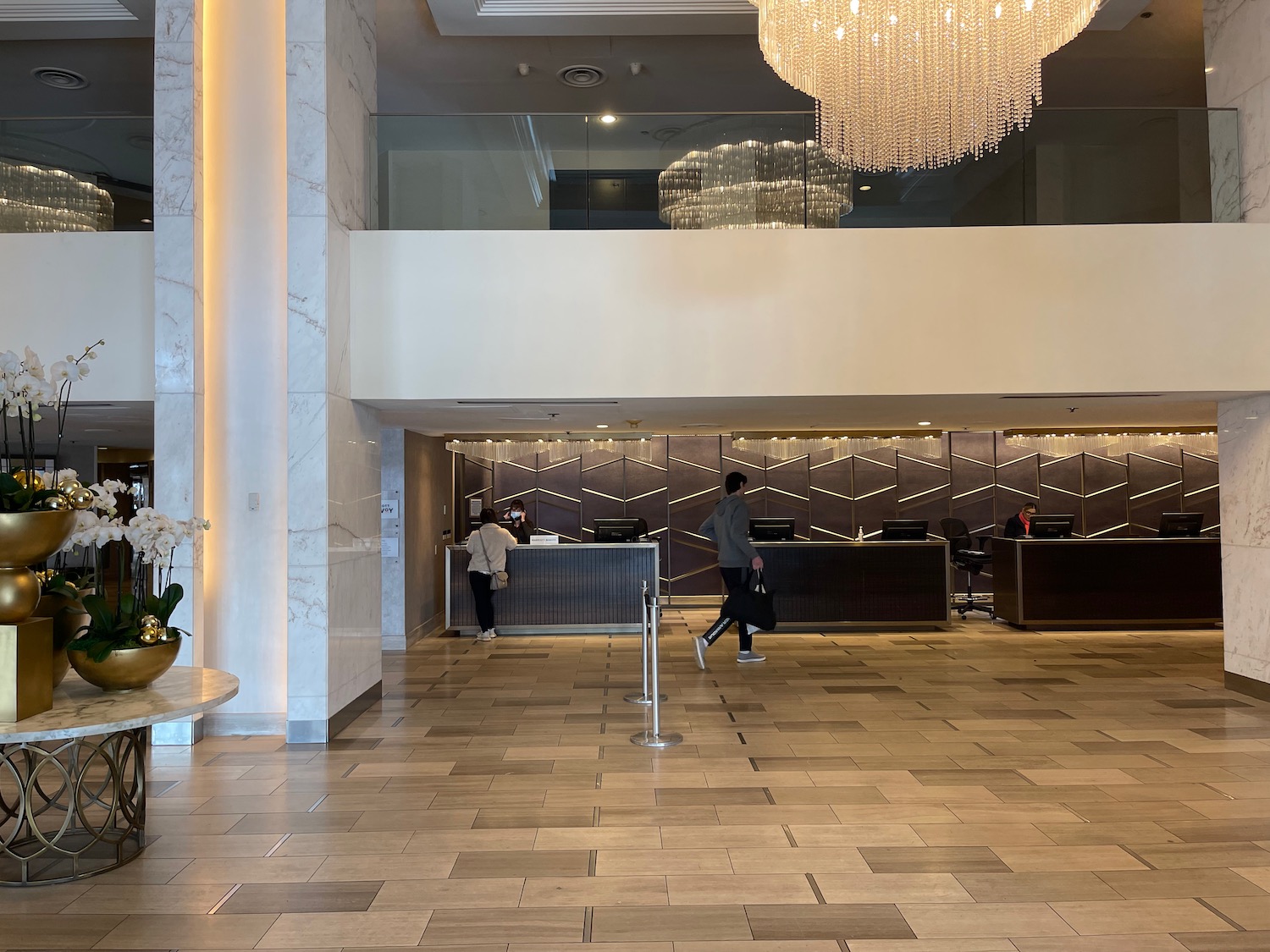 a lobby with a chandelier and people walking