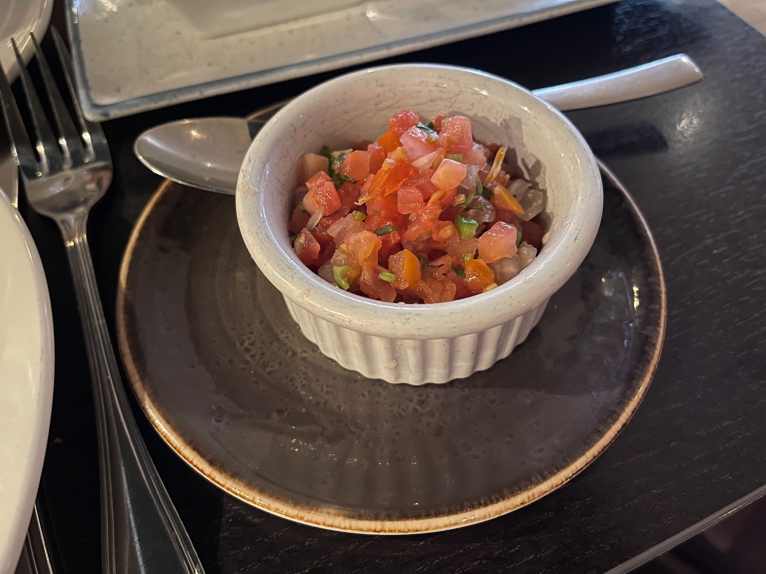 a bowl of salsa on a plate