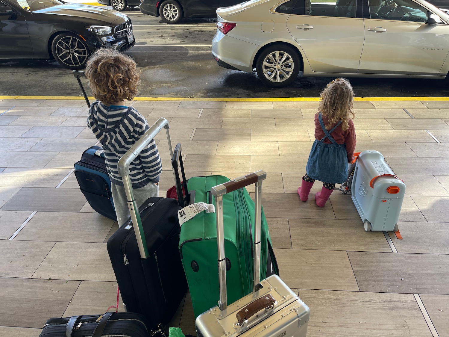 a group of children standing with luggage