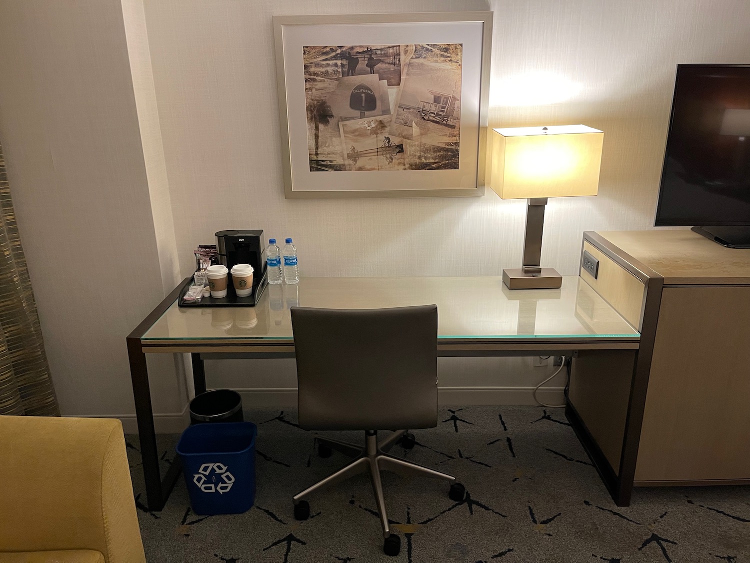 a desk with a chair and a lamp