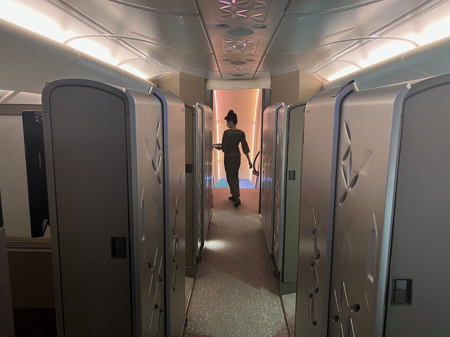 a person walking through a hallway with lockers