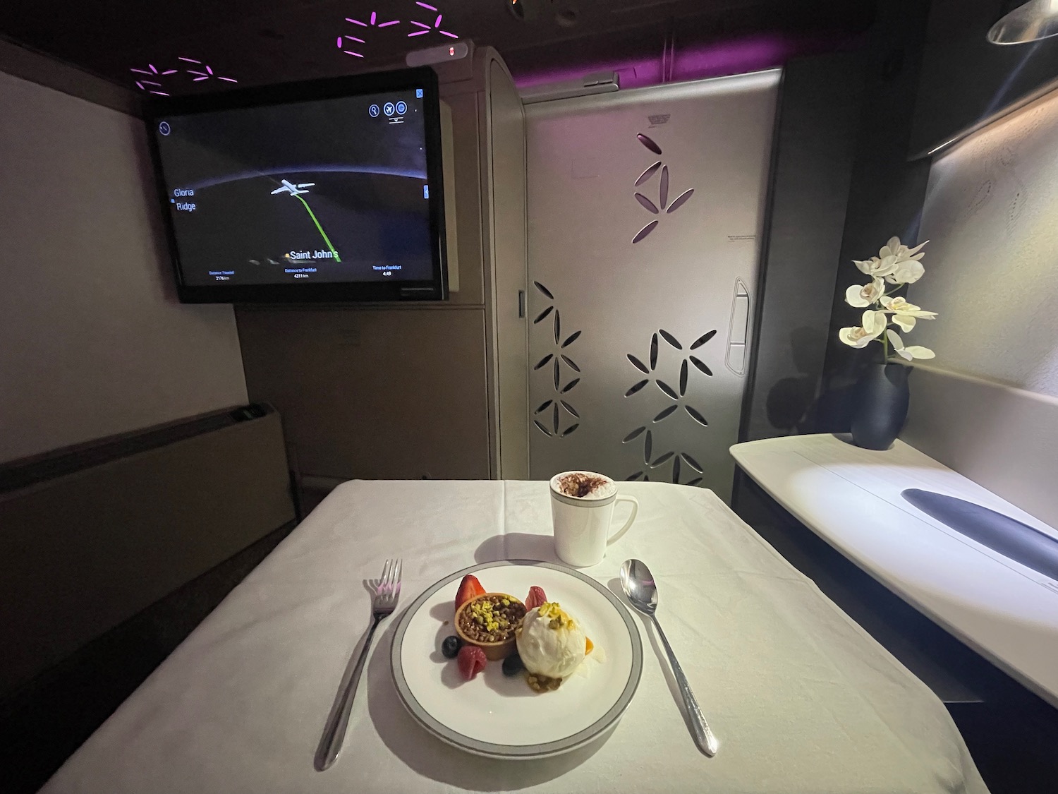 a plate of food on a table with a tv in the background