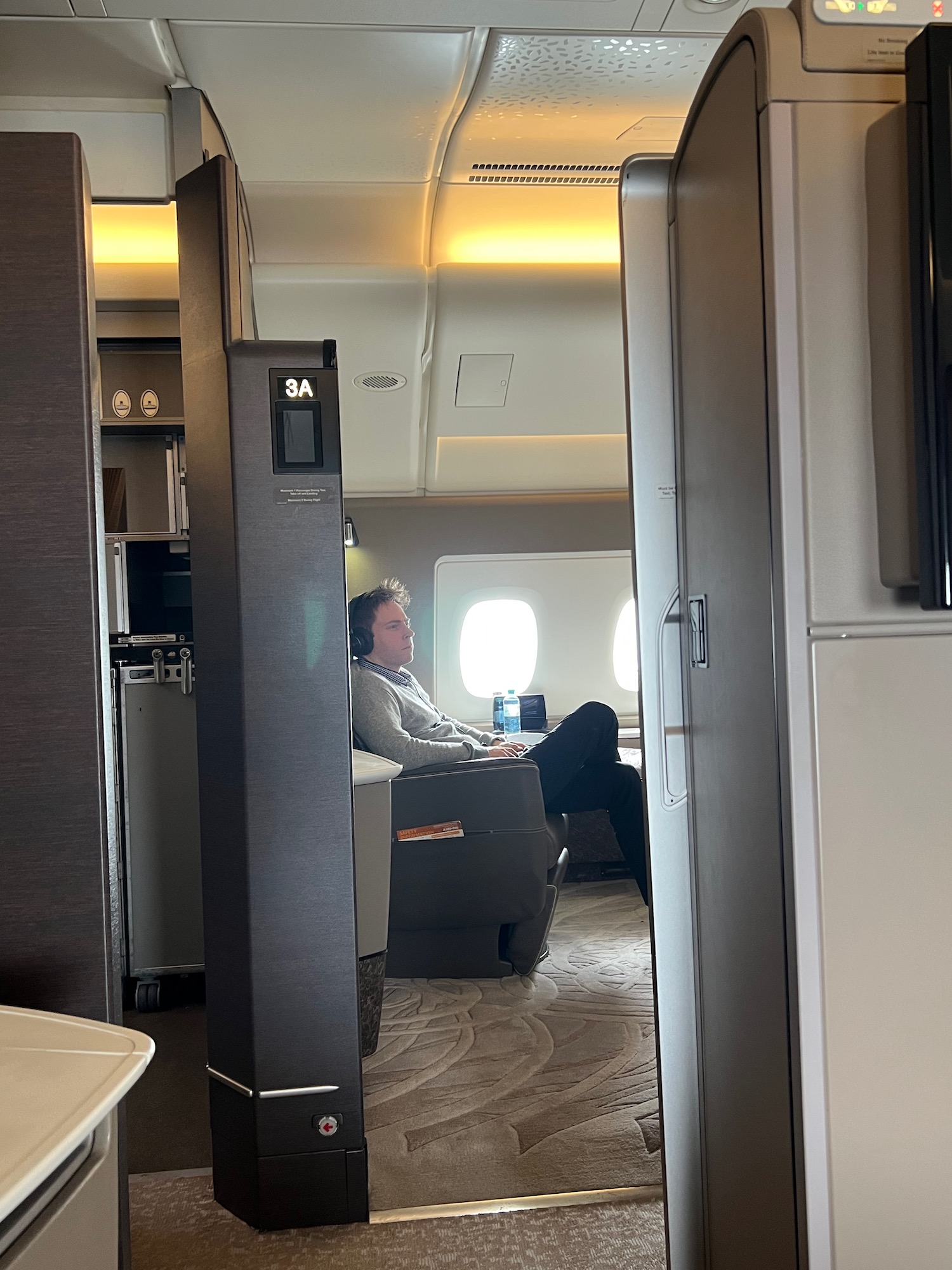 a man sitting in a chair in an airplane