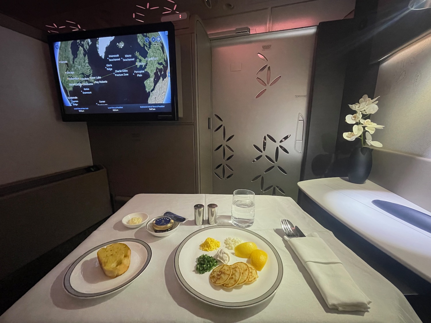 a table with plates of food and a television on it