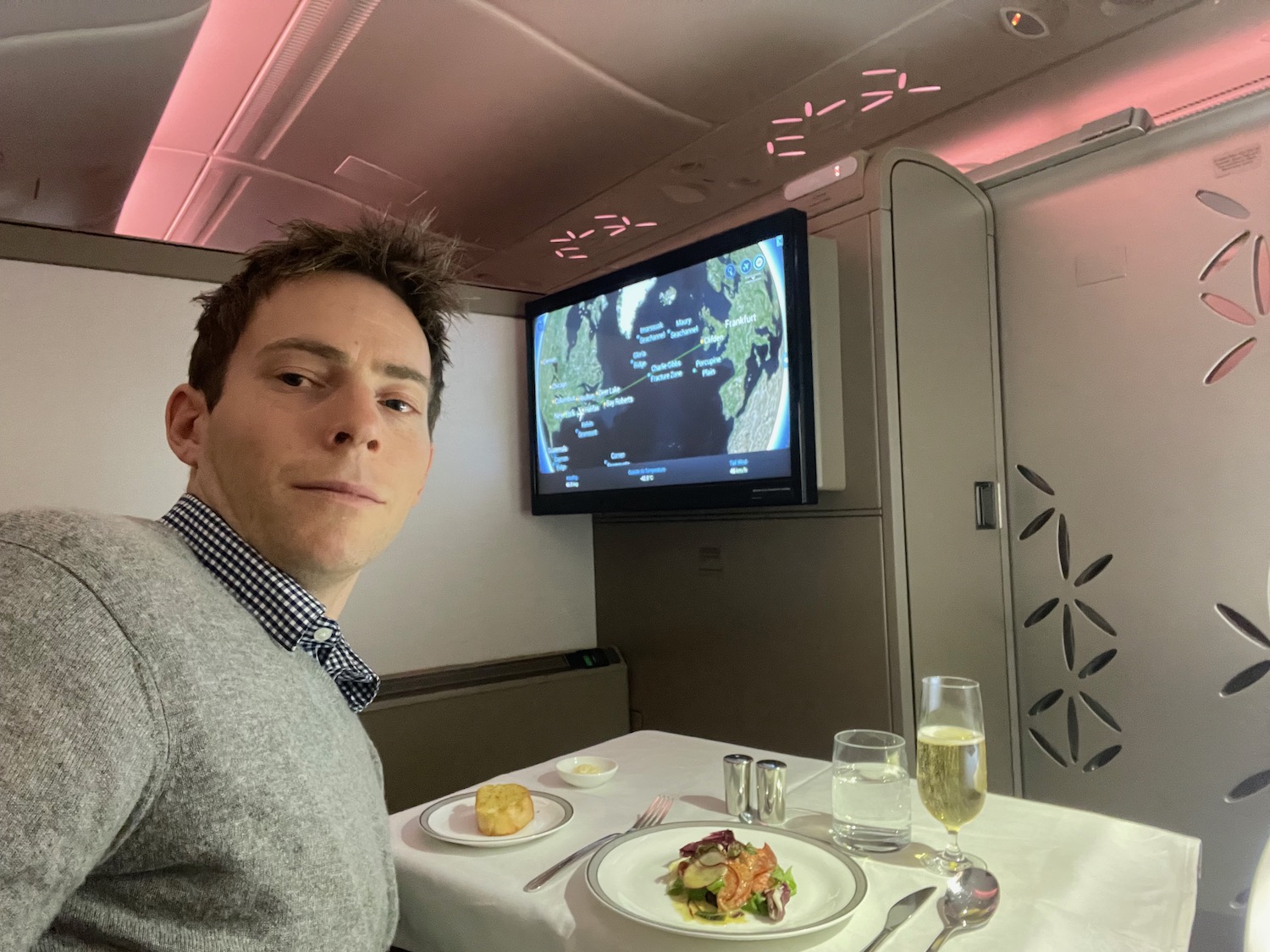 a man sitting at a table with food on it