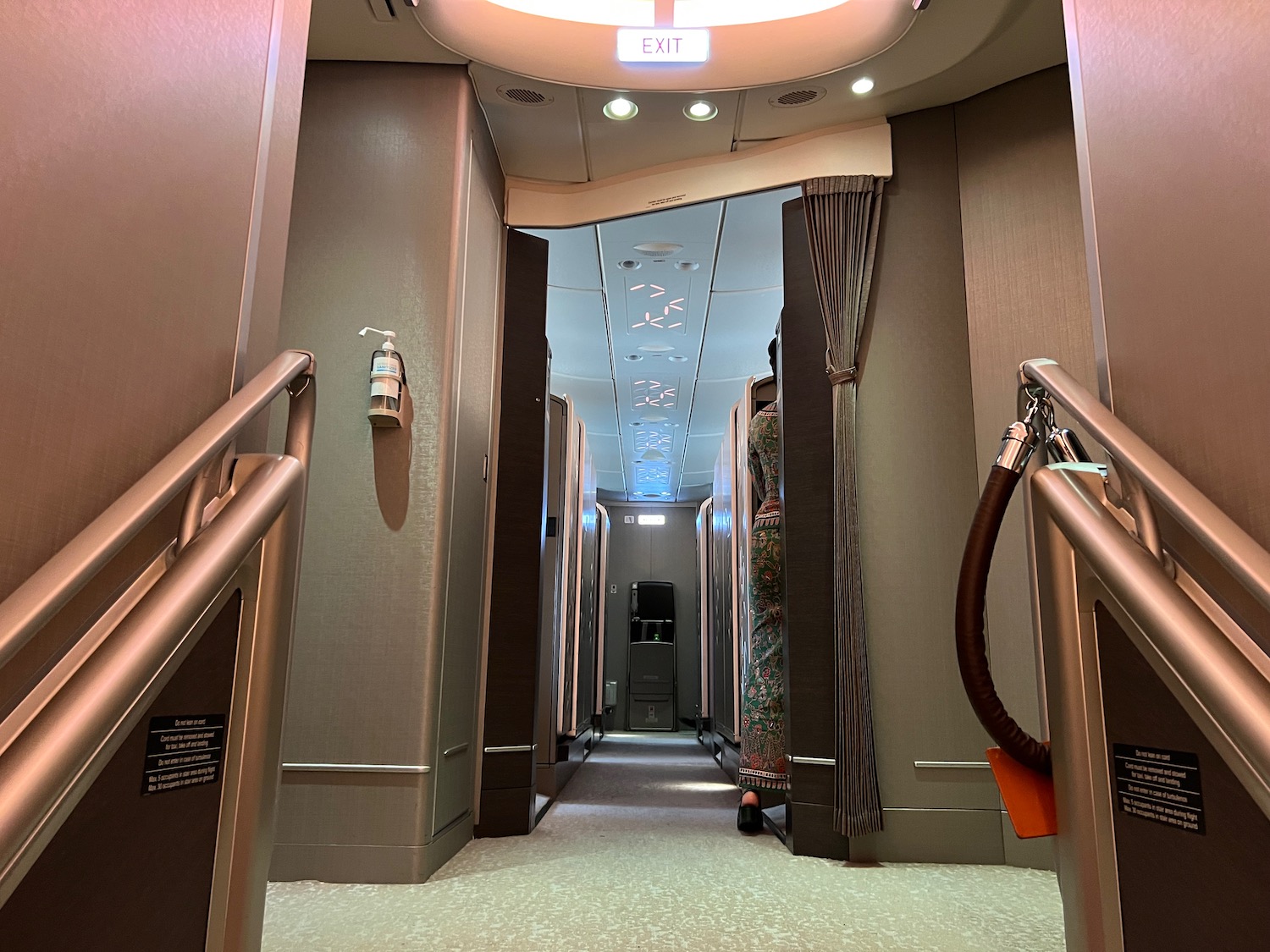 a hallway with stairs and a light on the ceiling