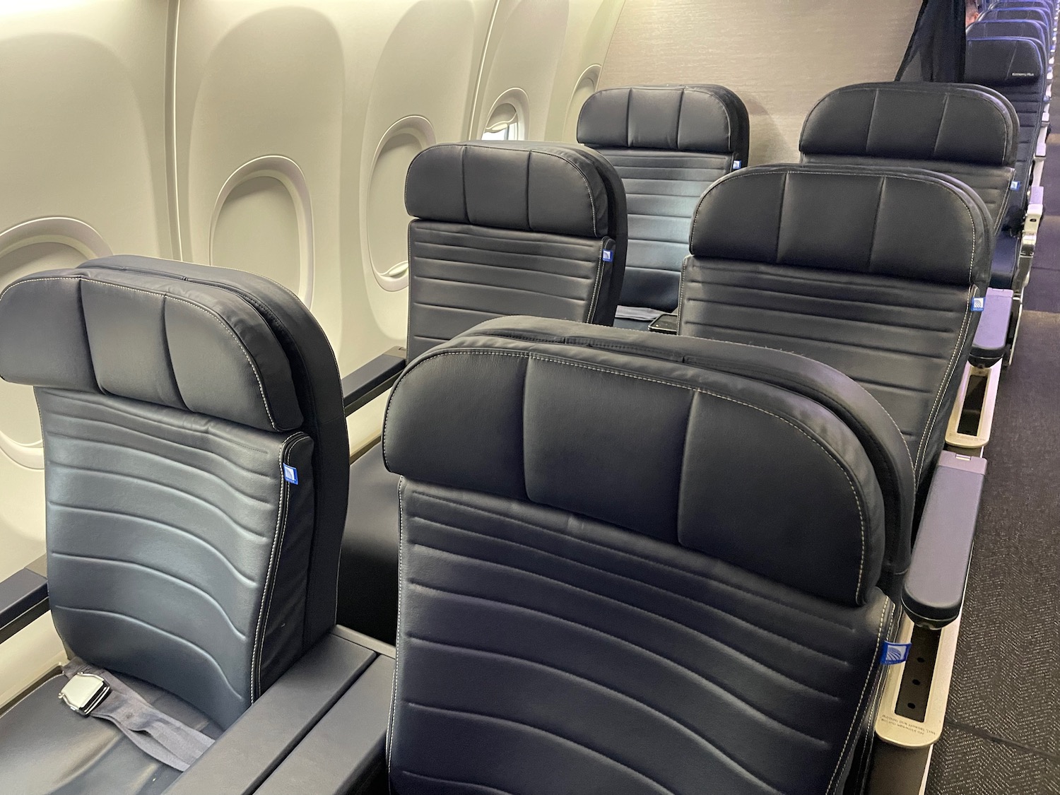 a row of black seats in an airplane