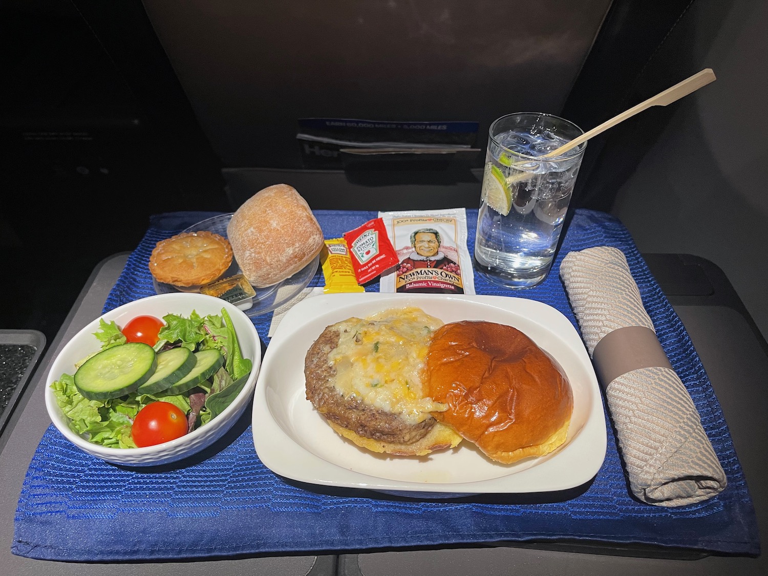 a plate of food and a drink on a blue place mat