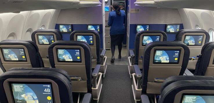 a woman standing in an airplane