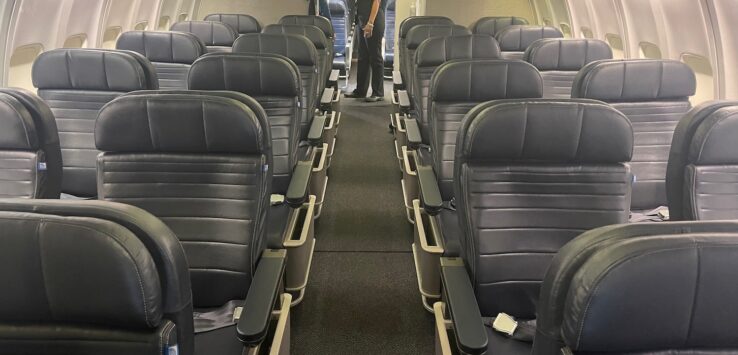 a man standing in the middle of an airplane