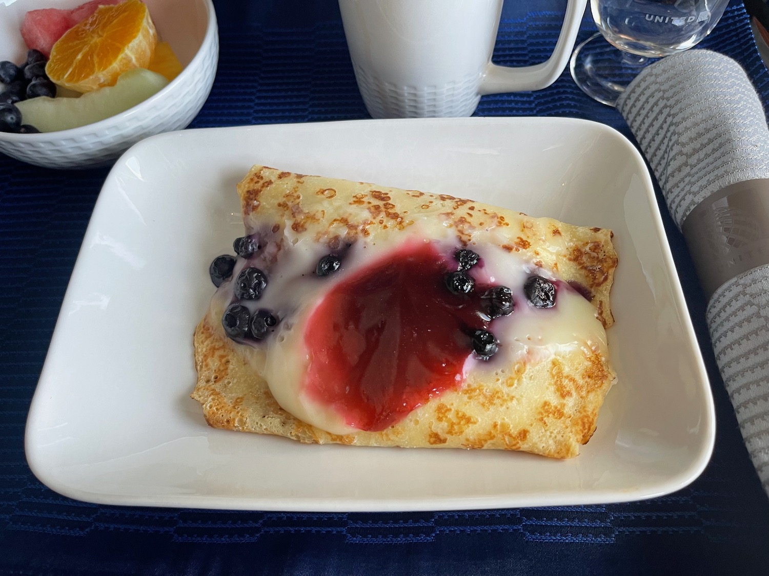 a crepe with fruit on a plate