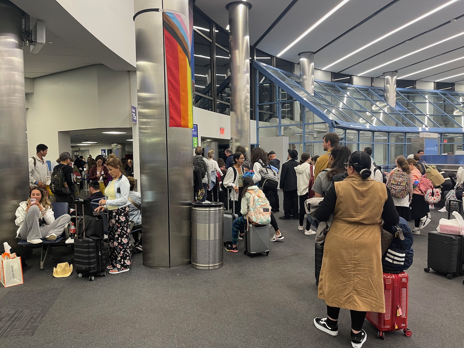 a group of people standing in a line in an airport