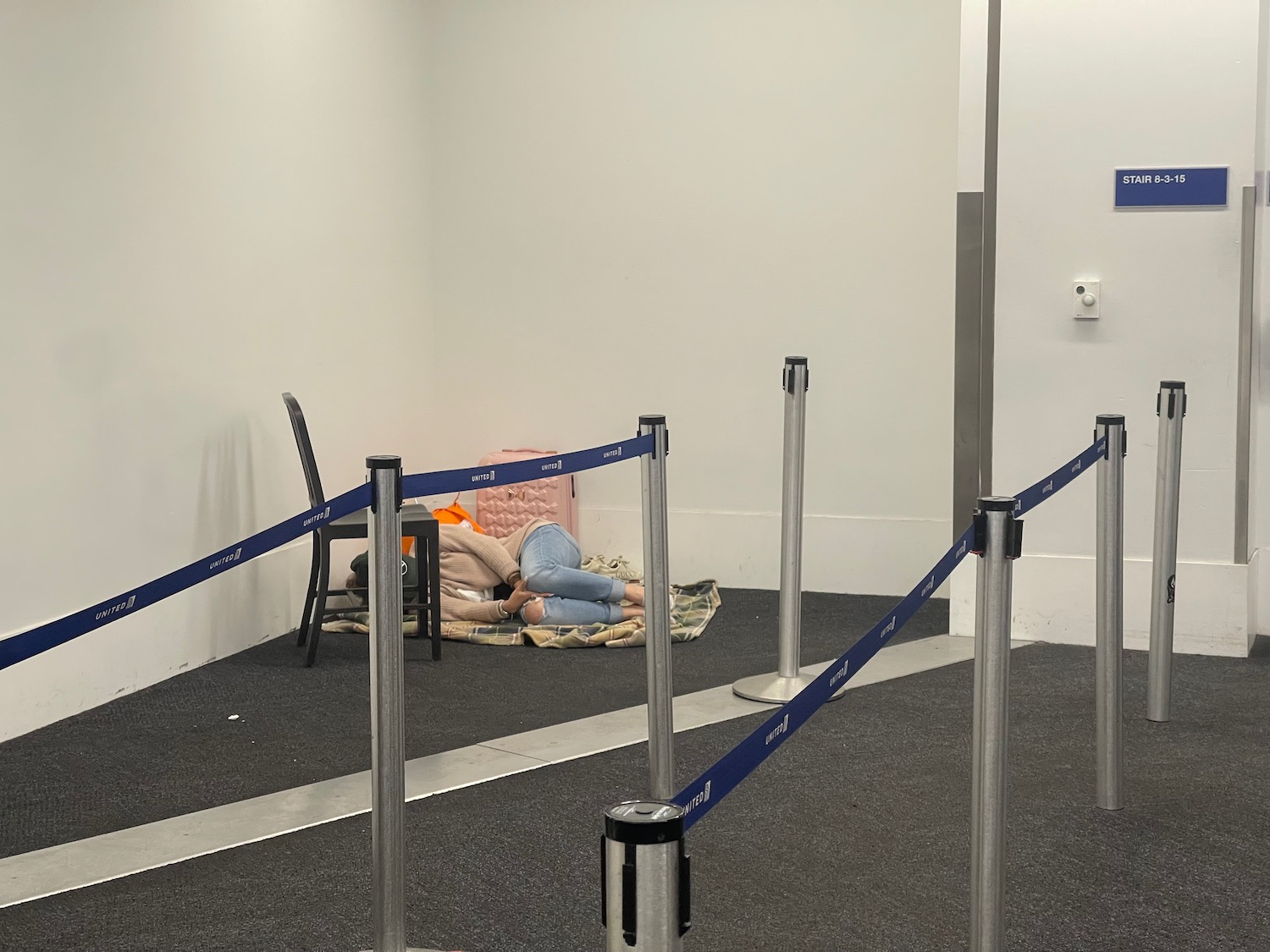 a person lying on a blanket in a room with a blue rope