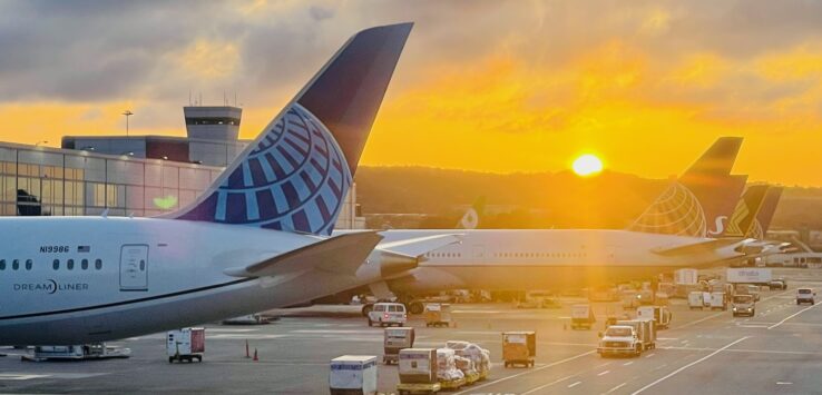 a group of airplanes parked at an airport