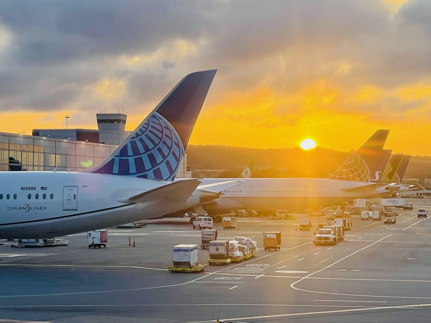 a group of airplanes parked at an airport