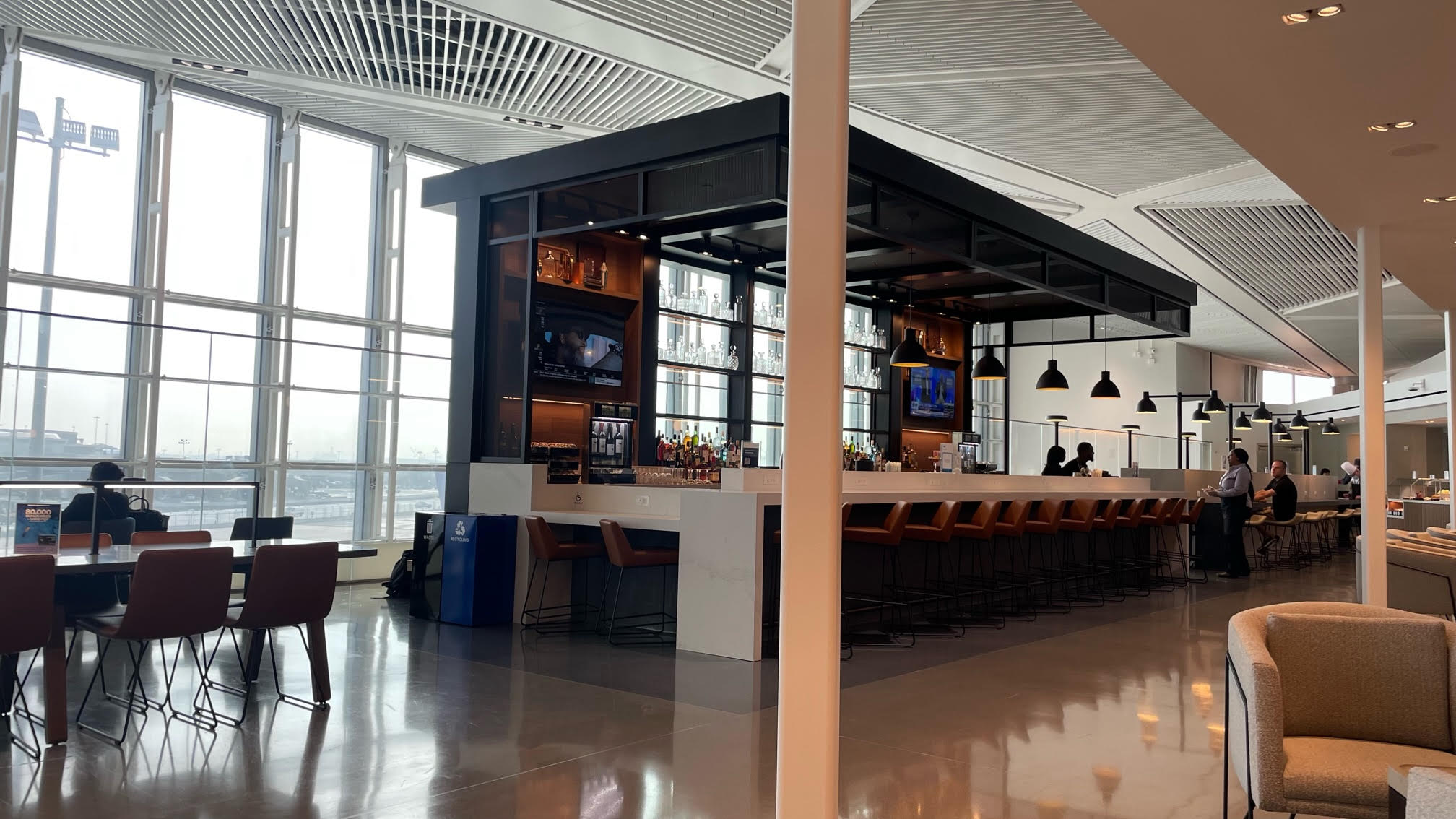 a bar with a bar and chairs in a building