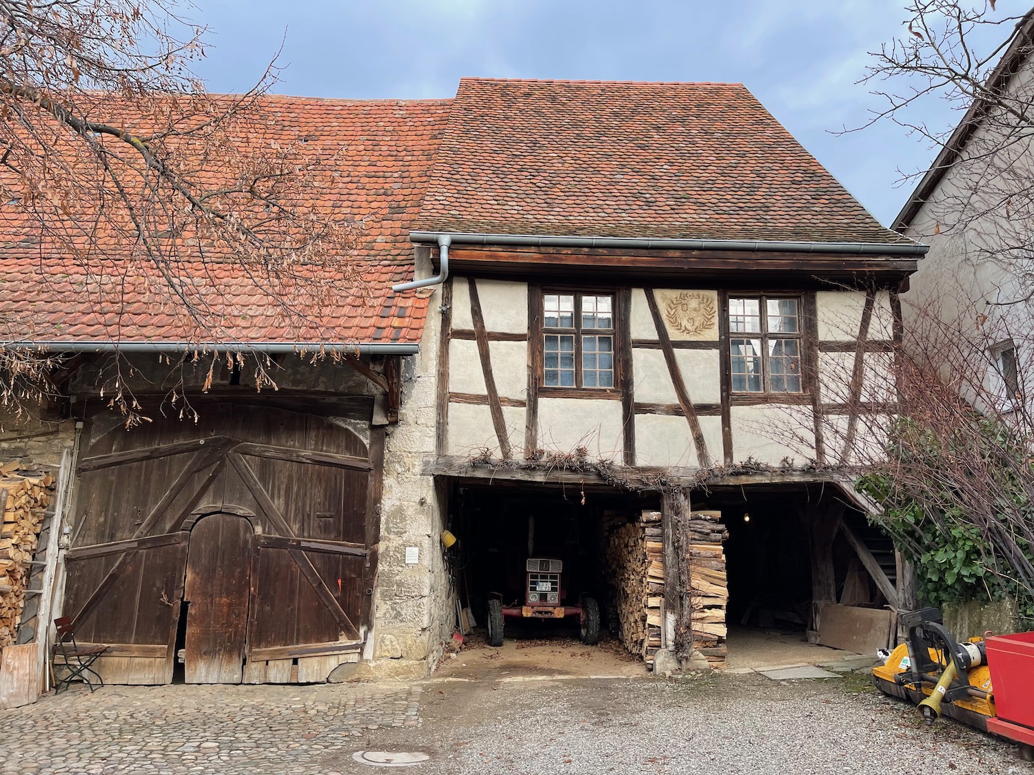 Paul Revere House with a garage and a car parked in front of it