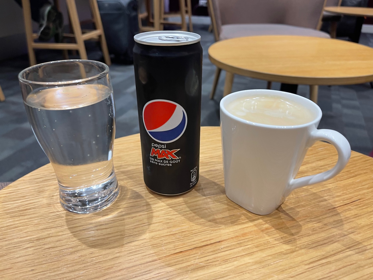 a can and a cup of liquid on a table