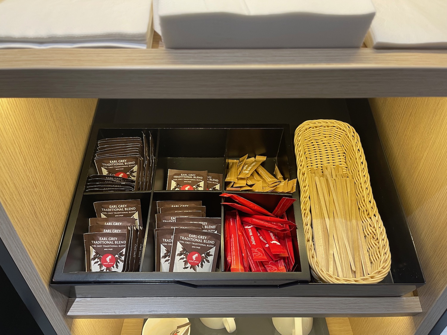 a drawer with a variety of condiments
