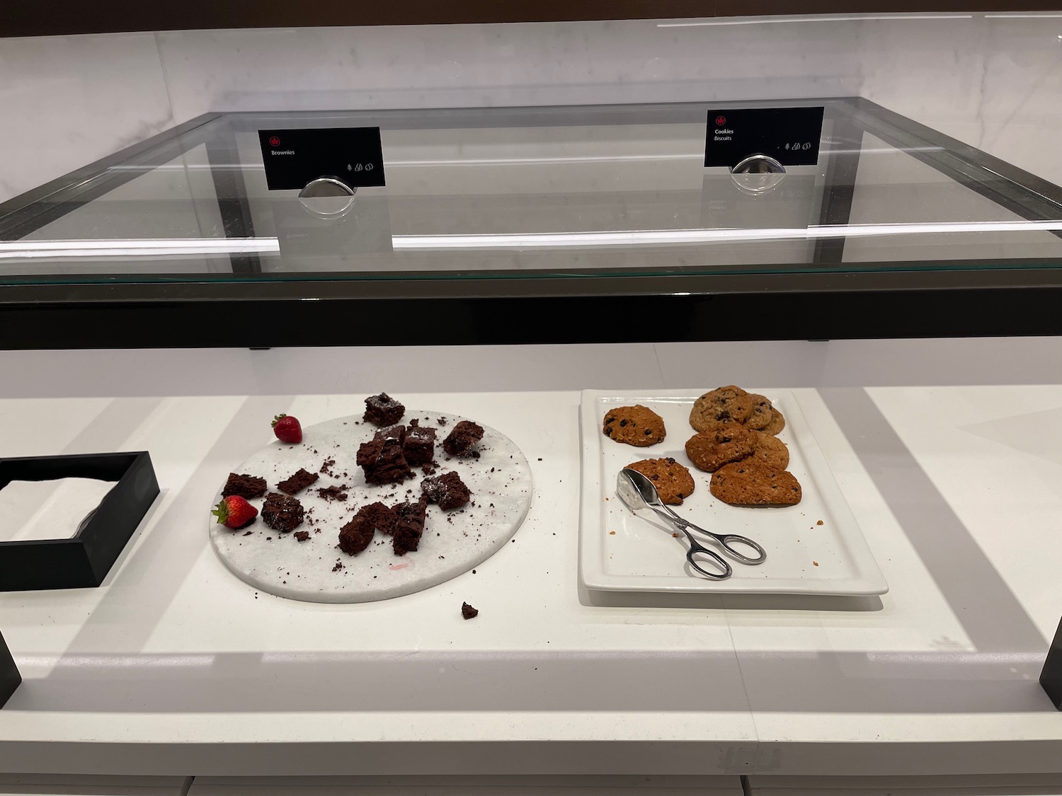 a plate of cookies and scissors on a counter