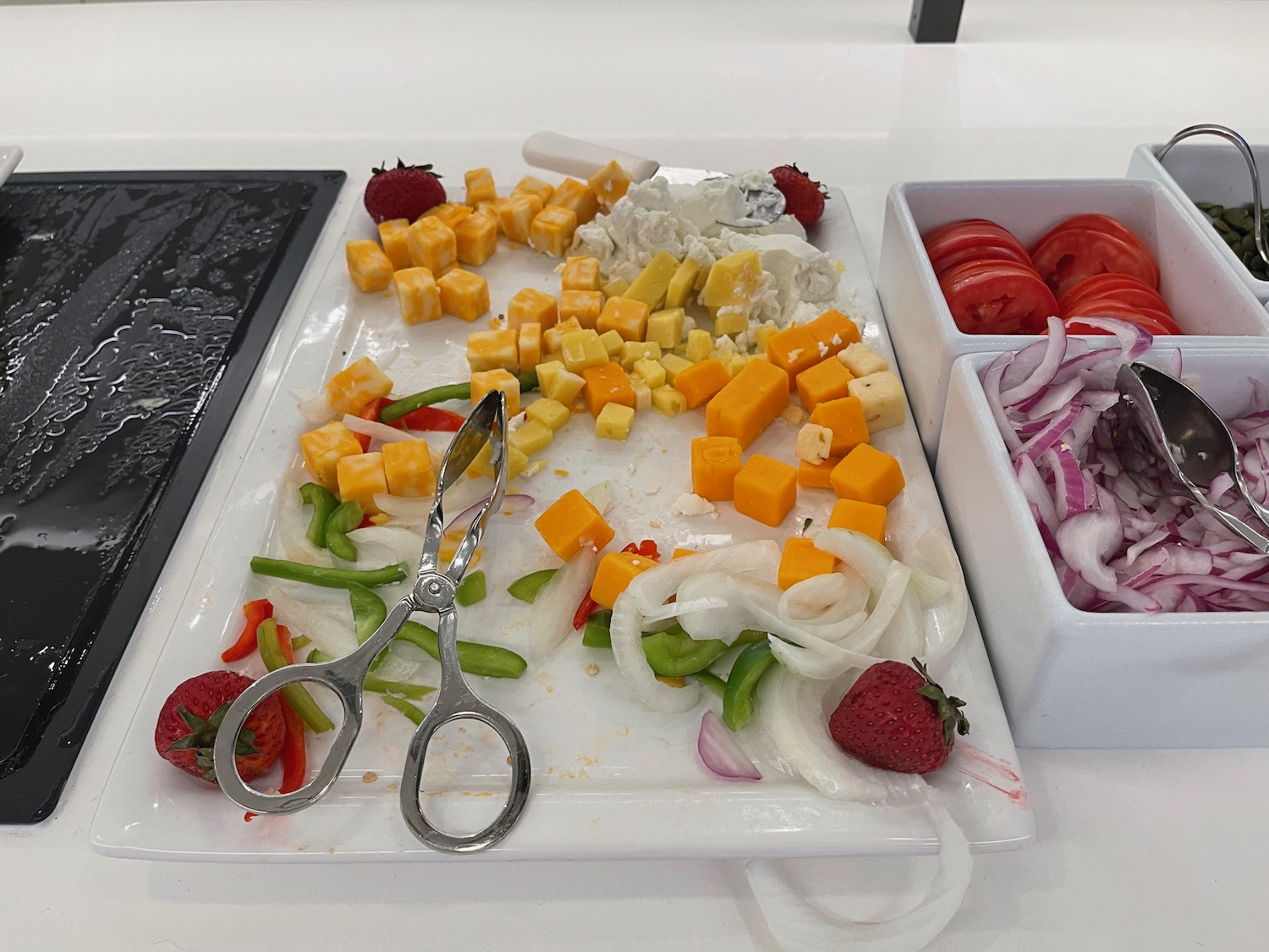 a plate of food with scissors and fruit