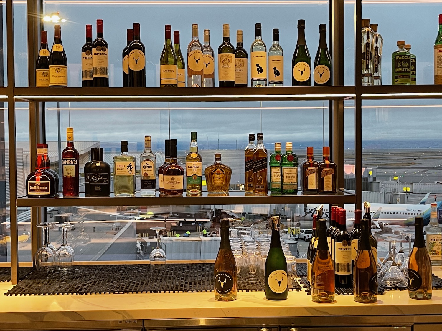 a shelf with bottles of alcohol