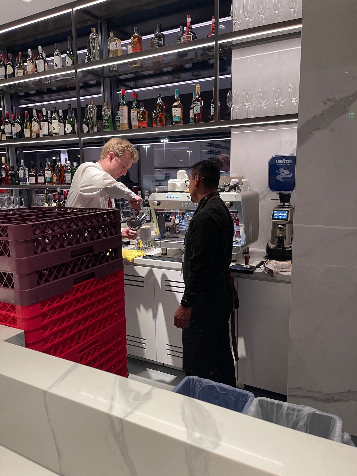 a man standing next to a man standing behind a counter