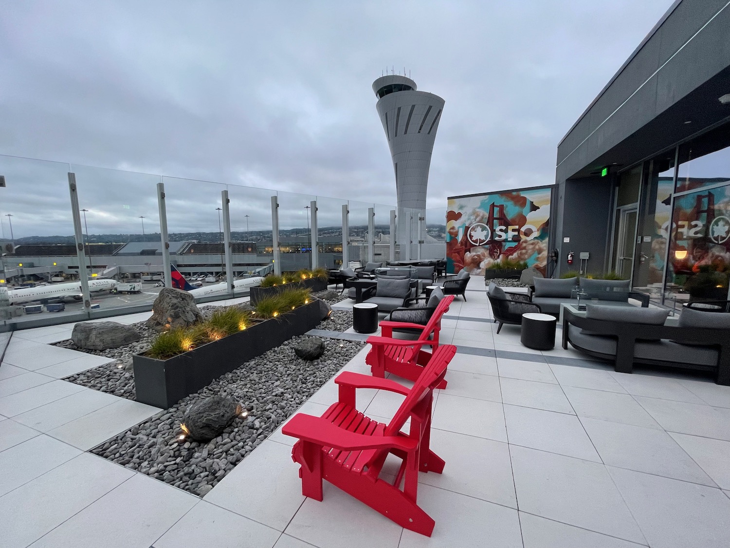 a building with a tower and chairs