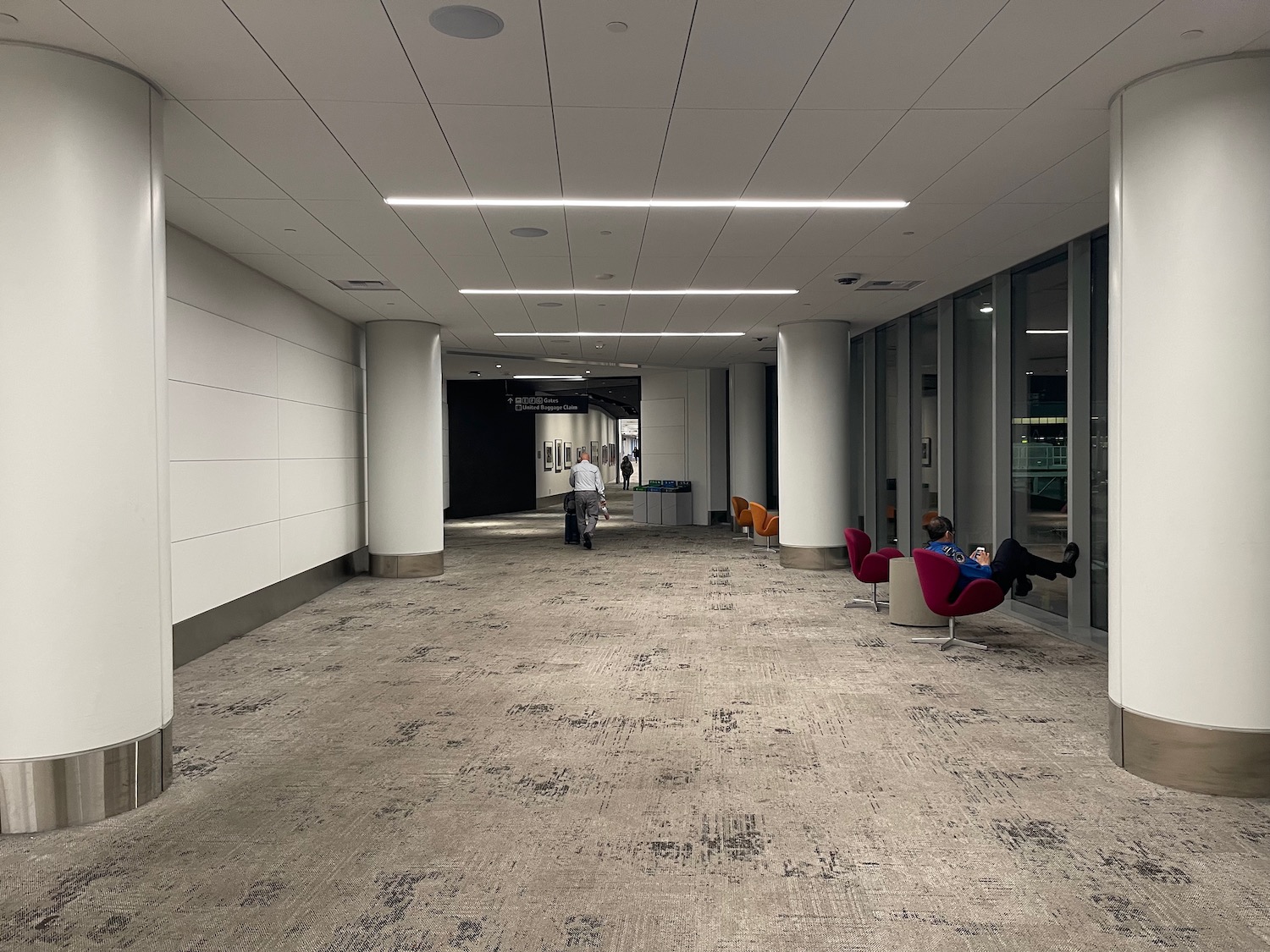 a person sitting in a chair in a hallway