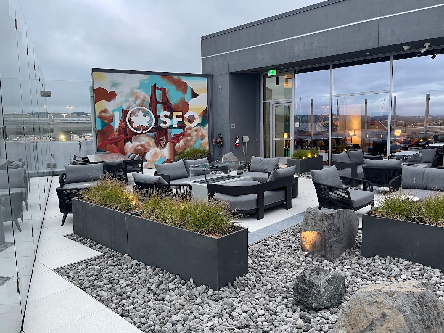 a patio area with chairs and a sign on the wall