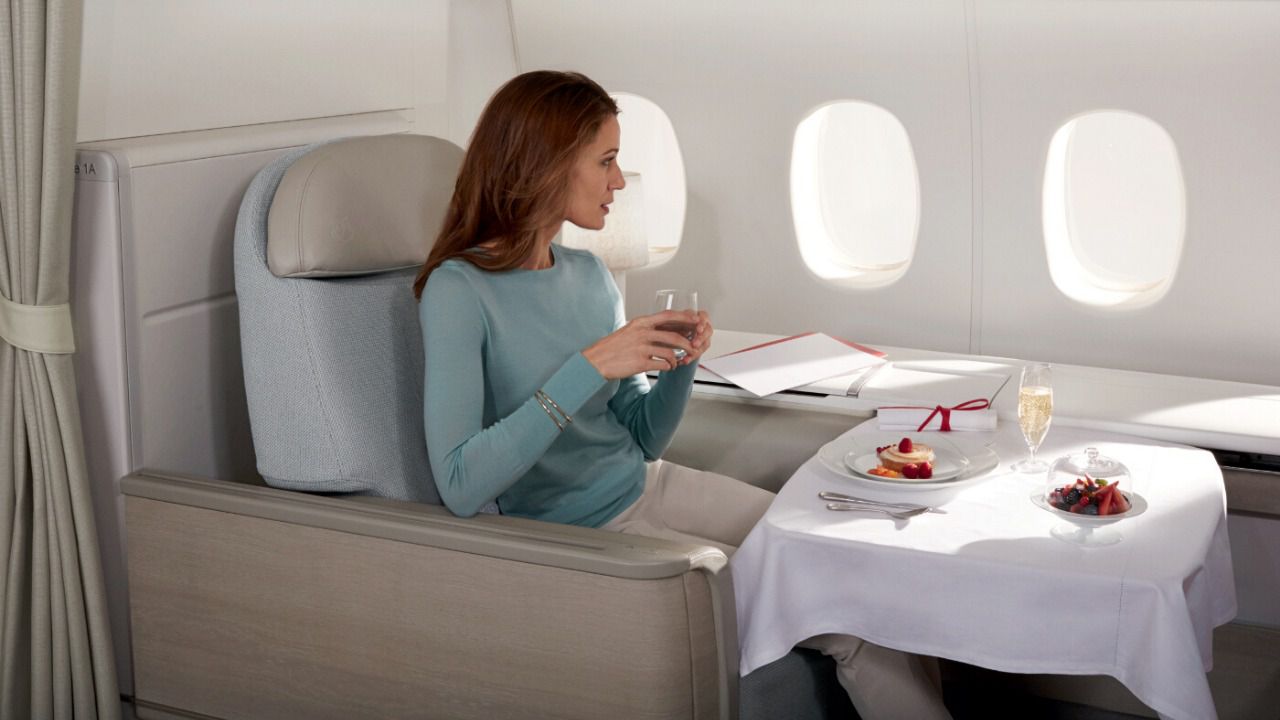 a woman sitting in a chair in a plane