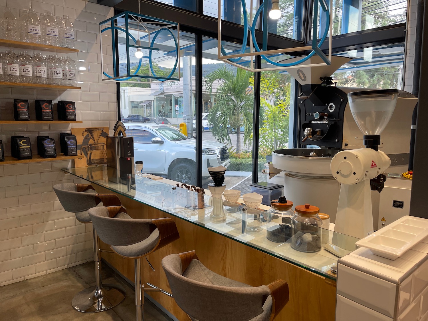 a coffee shop with a bar counter and chairs