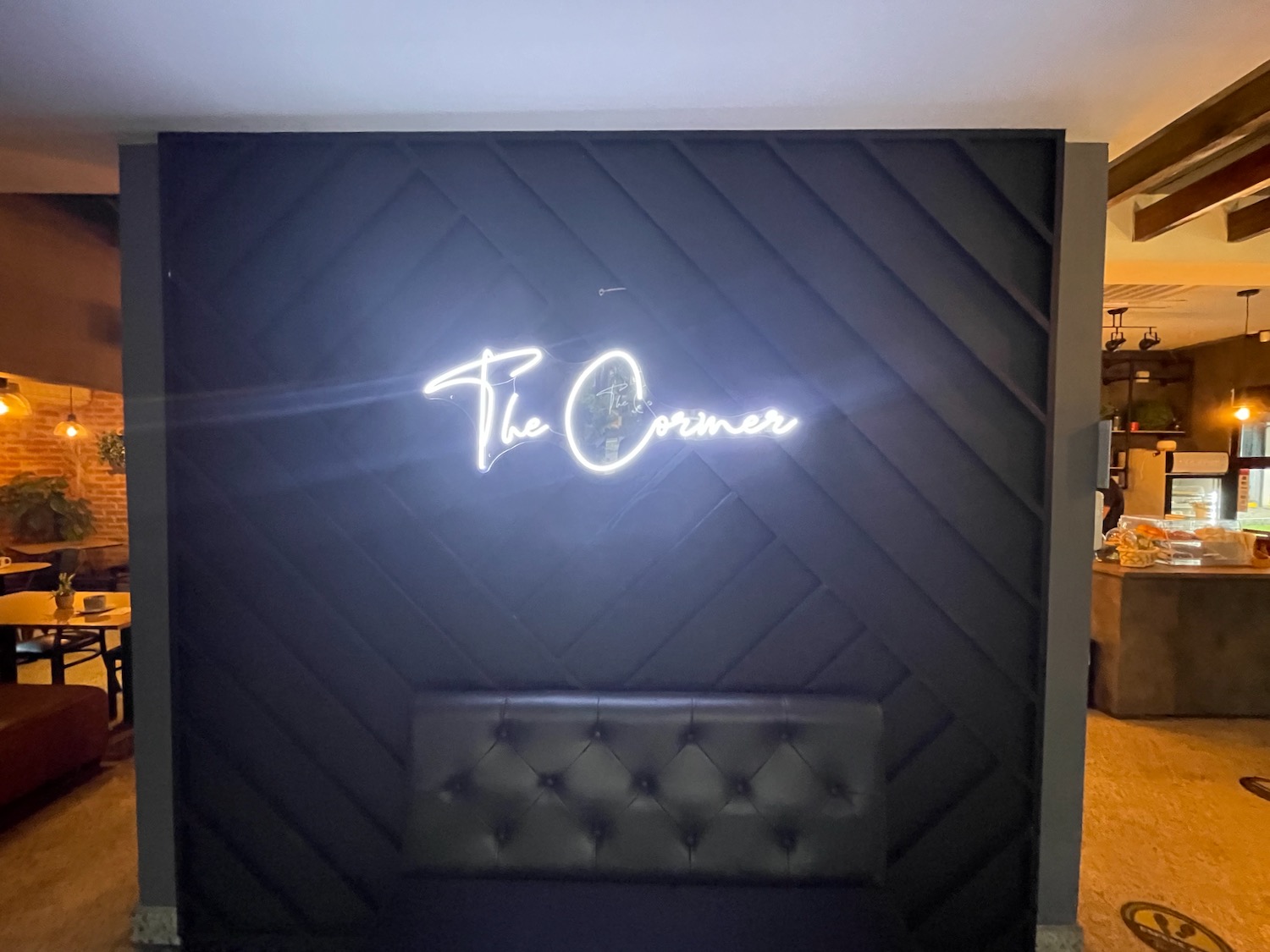 a black wall with a neon sign