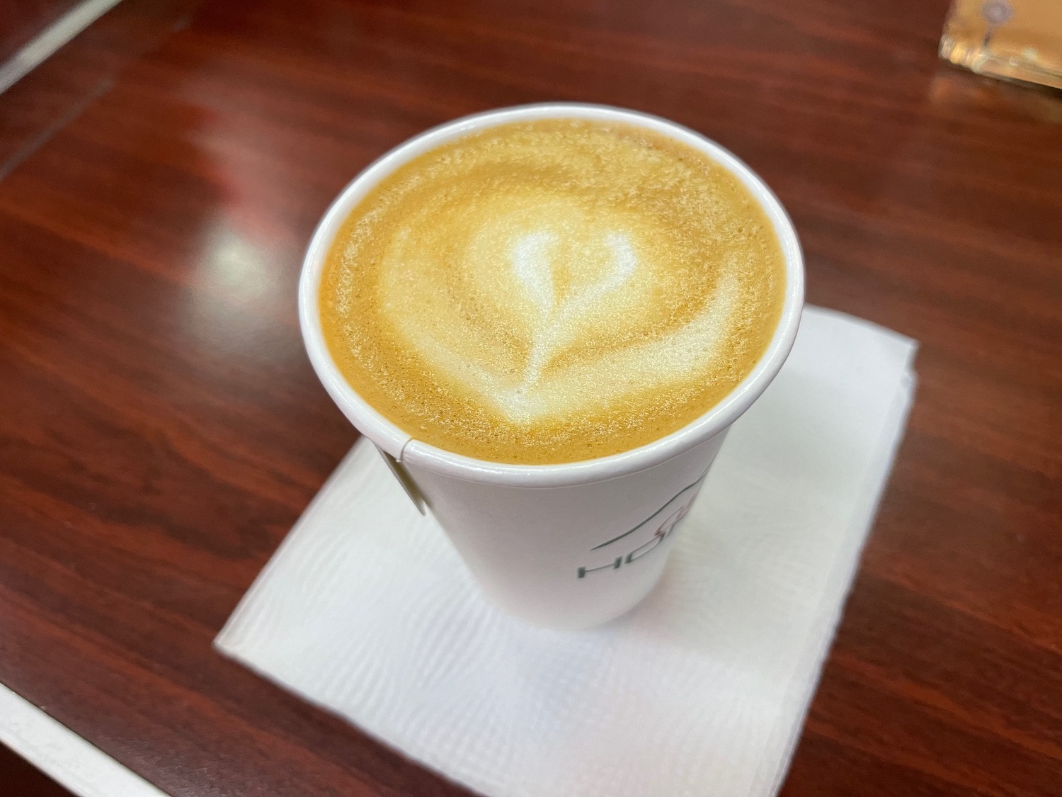 a cup of coffee with a heart shaped foam