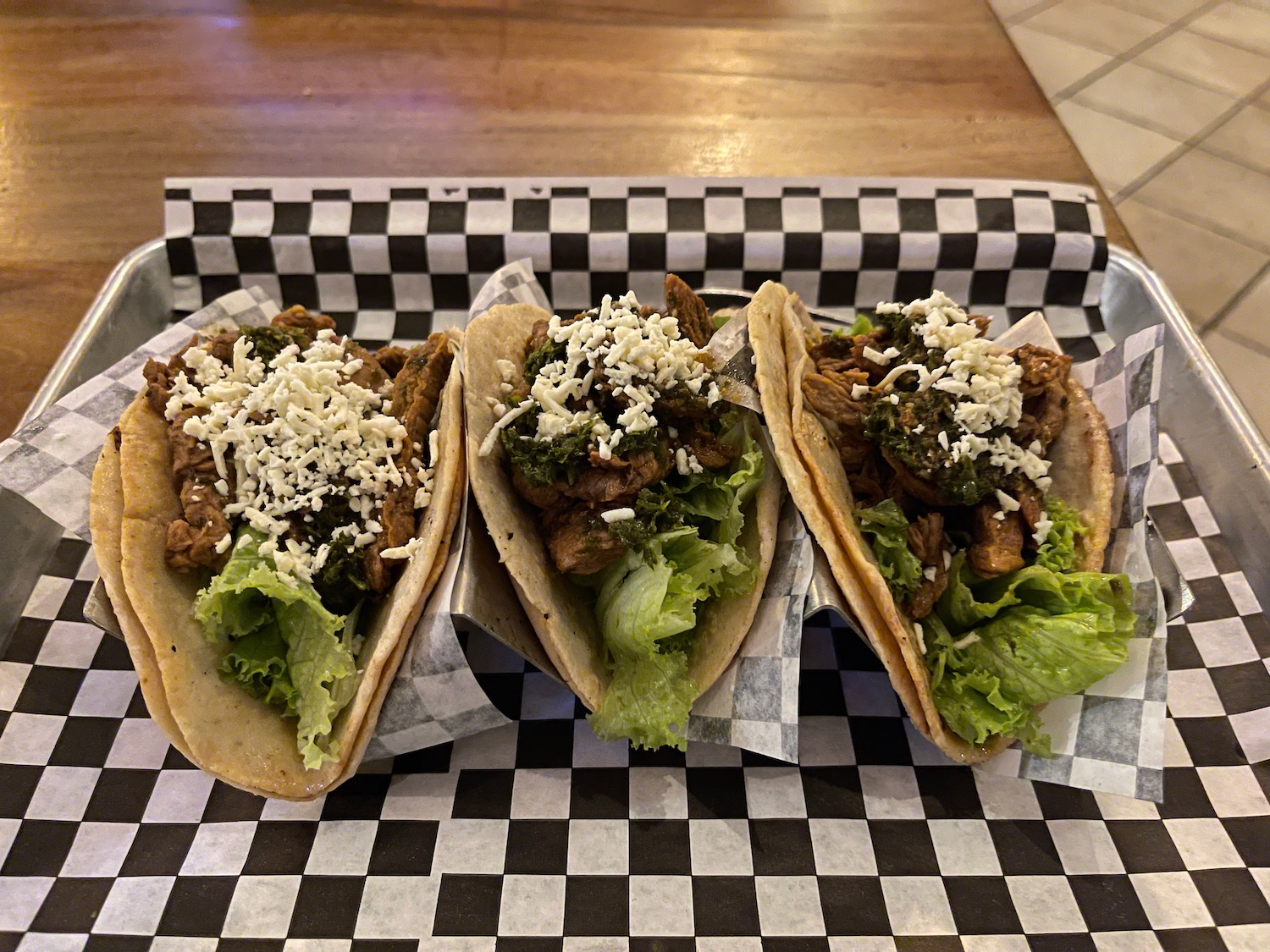 a group of tacos on a checkered surface